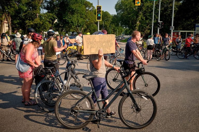 Bike Lane Network Adds Safer Junction Designs cyclists riding in a protected bike lane